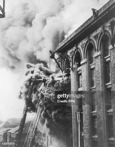 Firemen battle to extinguish a warehouse fire on Colonial Wharf, Wapping, 1935.