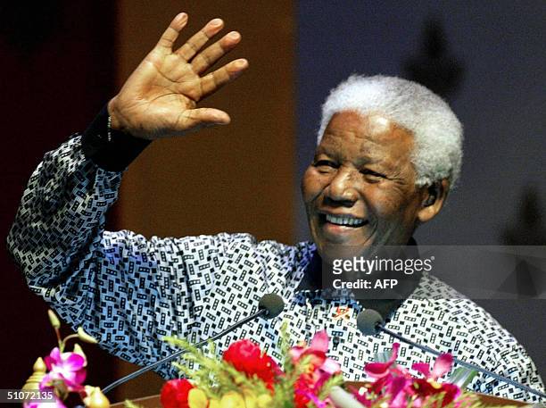 Former South African President, Nelson Mandela waves to delegates after delivering his speech as part of the 15th International AIDS Conference in...