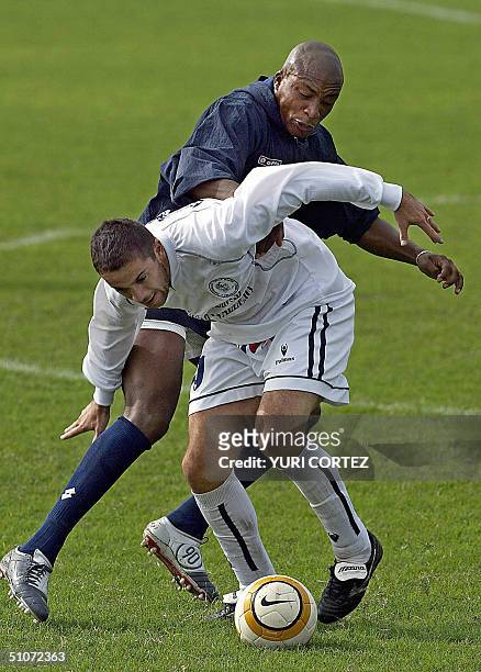 Colombian soccer player Edwin Congo fights for the ball with an unidentified Peruavian soccer player of the Cesar Vallejo University team during a...