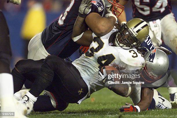 Ricky Williams of the New Orleans Saints is tackled by the New England Patriots during the game at Foxboro Stadium in Foxboro, Massachusettes . The...