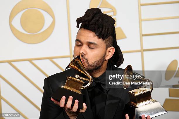 The Weeknd, winner of the Best R&B Performance award for 'Earned It,' and Best Urban Contemporary Album award for 'Beauty Behind The Madness,' poses...