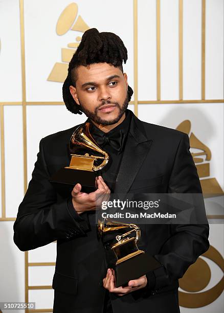 The Weeknd, winner of the Best R&B Performance award for 'Earned It,' and Best Urban Contemporary Album award for 'Beauty Behind The Madness,' poses...