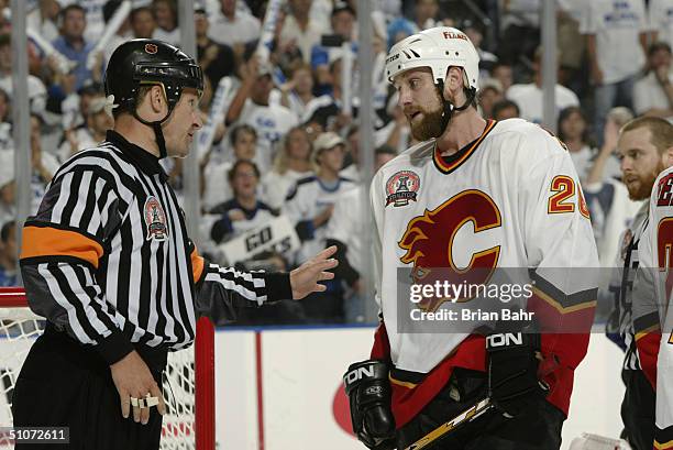 Robyn Regehr of the Calgary Flames talks to referee Stephen Walkom during Game five of the NHL Stanley Cup Finals against the Tampa Bay Lightning on...