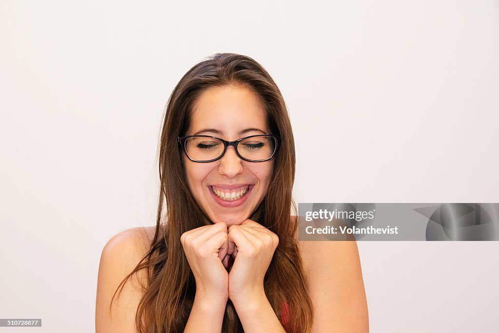 Girl with glasses laughing with excitement