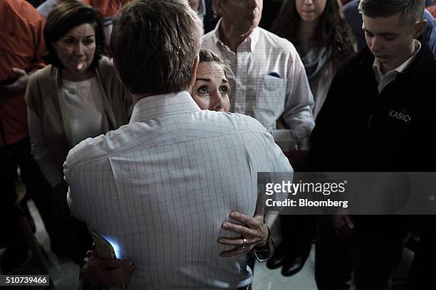 John Kasich, governor of Ohio and 2016 Republican presidential candidate, embraces an attendee during a town hall event at Murray's Neighborhood Bar...