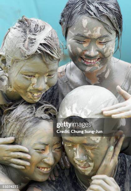 Young participant s enjoy the mud on the West Coast beach during the Boryeong Mud Festival on July 16, 2004 in Daecheon, South Korea. This is the...