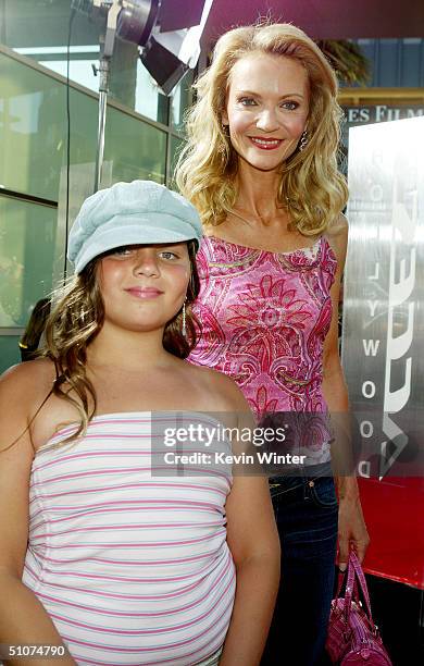 Actress Joan Allen and daughter Sadie arrive at the premiere of Universal's "The Bourne Supremacy" at the Arclight Cinemas on July 15, 2004 in Los...