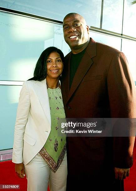 Former basketball player Earvin "Magic" Johnson and wife Cookie arrive at the premiere of Universal's "The Bourne Supremacy" at the Arclight Cinemas...