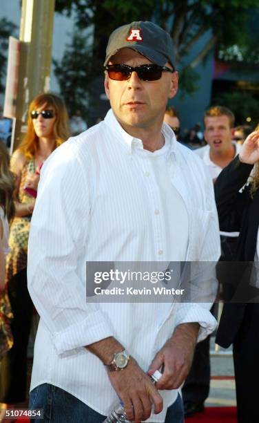 Actor Bruce Willis arrives at the premiere of Universal's "The Bourne Supremacy" at the Arclight Cinemas on July 15, 2004 in Los Angeles, California.