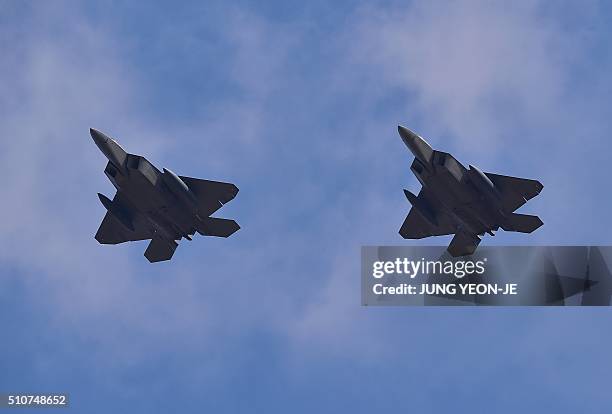 Stealth fighters fly over Osan Air Base in Pyeongtaek, south of Seoul, on February 17, 2016. The radar-evading aircraft flew across South Korea on...