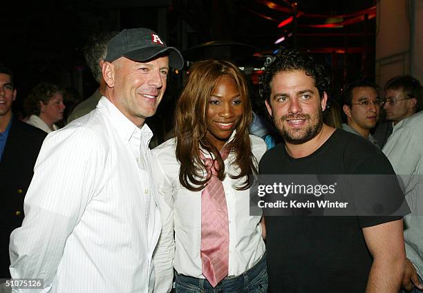 Actor Bruce Willis, tennis player Serena Williams and director Brett Ratner pose at the after party for the premiere of Universal's "The Bourne...