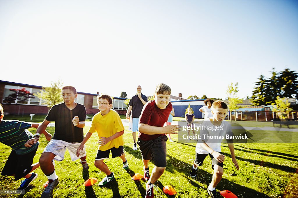 Group of boys starting running race during class