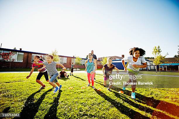 group of girls running race during athletics class - community health centre stock pictures, royalty-free photos & images