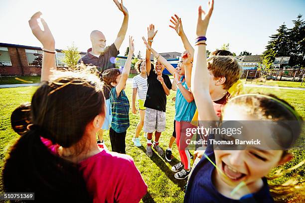 coach and group of kids cheering after huddle - building dedication stock pictures, royalty-free photos & images