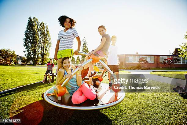 portrait of smiling kids on merry go round - 13 year old girls in shorts stock pictures, royalty-free photos & images