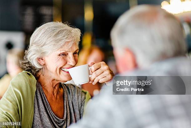 happy couple having coffee in restaurant - restaurant happy couple stock pictures, royalty-free photos & images