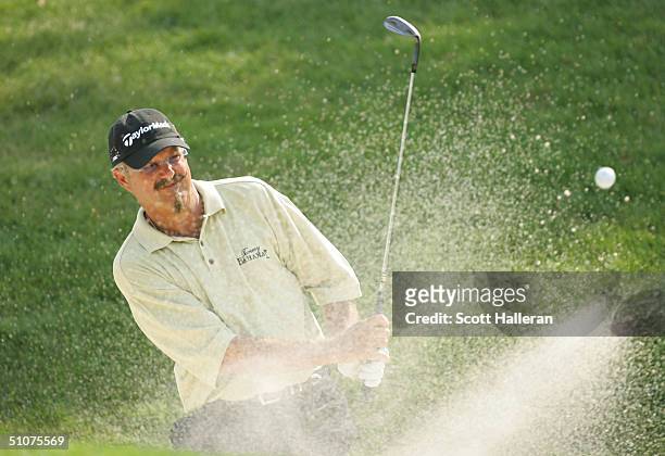 Gary McCord hits a bunker shot during the final round of the Ford Senior Players Championship at the TPC of Michigan on July 11, 2004 in Dearborn,...