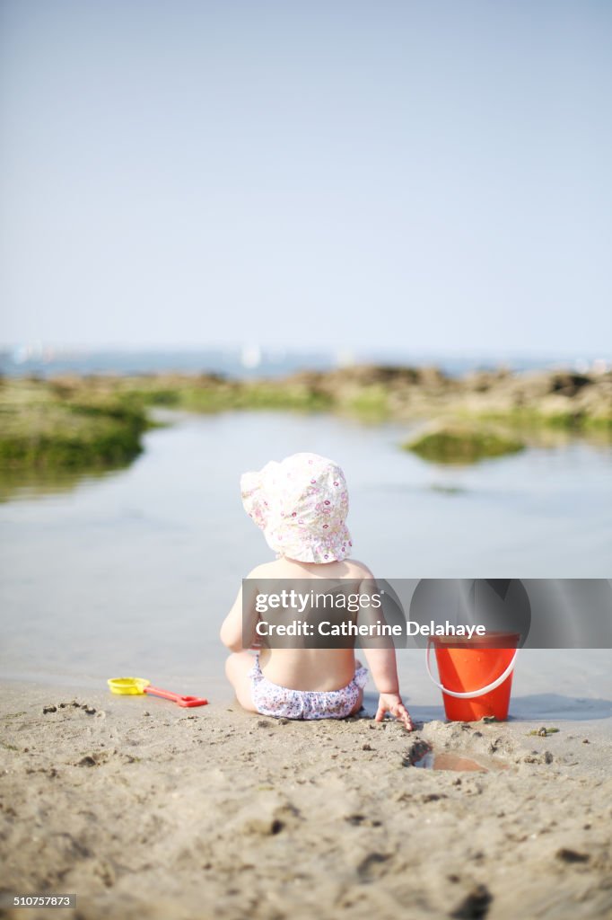 A 1 year old baby girl on the beach