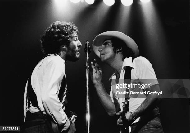 American rock and roll musicians Bruce Springsteen & Steven Van Zandt harmonize togather while they perform on stage, mid 1970s.