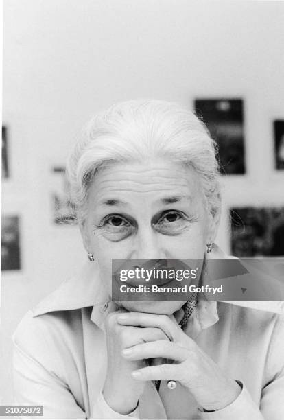 Portrait of American photographer Eve Arnold as she rests her chin on her clasped hands, 1982.