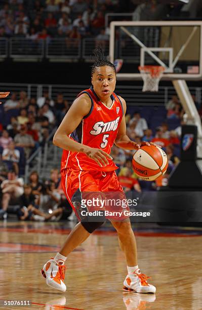 Dawn Staley of the Charlotte Sting dribbles the ball against the Phoenix Mercury during a WNBA game played on June 11, 2004 at America West Arena in...
