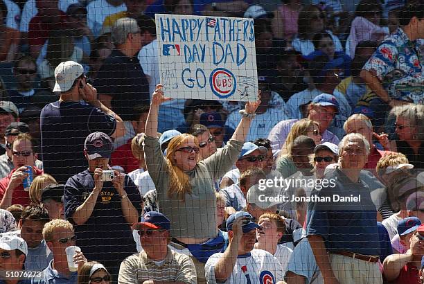 Fan of the Chicago Cubs holds up a fathers day sign during the interleague game against the Oakland Athletics on June 20, 2004 at Wrigley Field in...