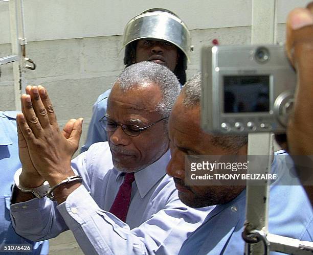 Former Haitian Prime Minister Yvon Neptune arrives at a Haitian courthouse 16 July for arraignment. Neptune has been under detention for his alleged...