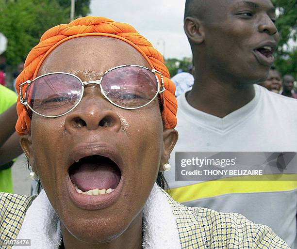 Supporters of former Haitian Prime Minister Yvon Neptune demonstrate outside a courthouse in Port-au-Prince 16 July demanding justice for Neptune,...