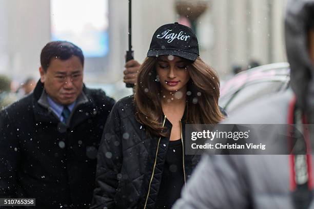 Victoria"u2019s Secret model Taylor Marie Hill wearing a black bomber jacket and a Taylor cap seen outside Jeremy Scott during New York Fashion Week:...