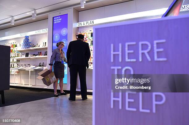 An employee serves a customer inside a Telstra Corp. Discovery store in Melbourne, Australia, on Tuesday, Feb. 9, 2016. Telstra, Australia's biggest...