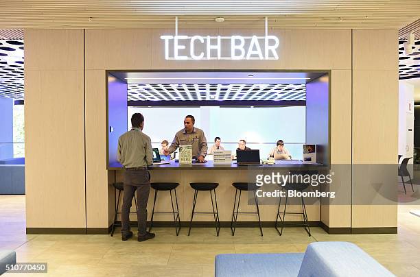 Employees stand at the Tech Bar inside a Telstra Corp. Discovery store in Melbourne, Australia, on Tuesday, Feb. 9, 2016. Telstra, Australia's...