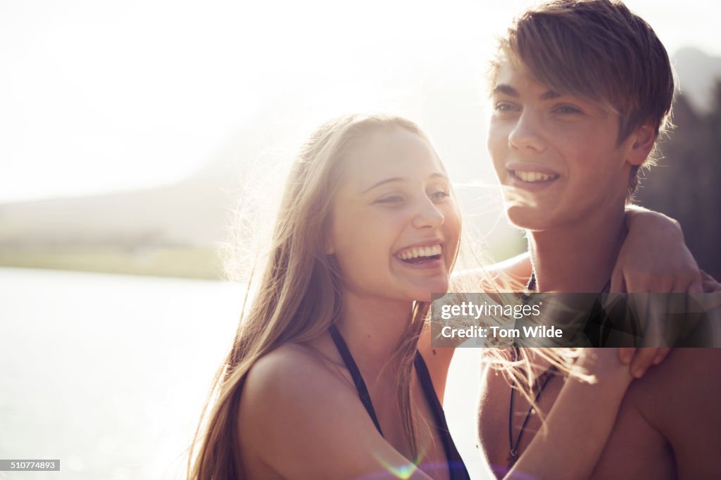 Young couple laughing as they embrace