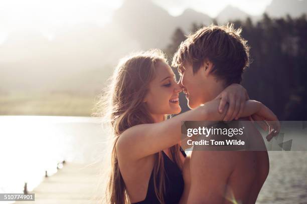 young couple about to kiss in a natural environmen - peck stock pictures, royalty-free photos & images