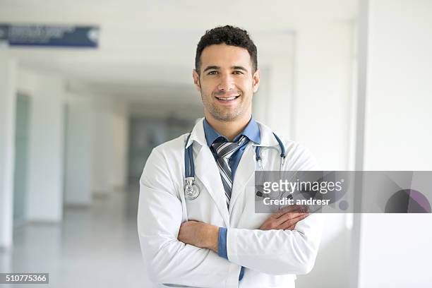 junger arzt im krankenhaus - handsome doctors stock-fotos und bilder