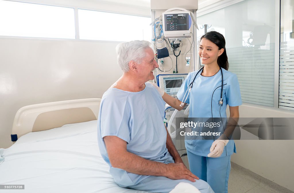 Senior man at the ICU talking to the nurse