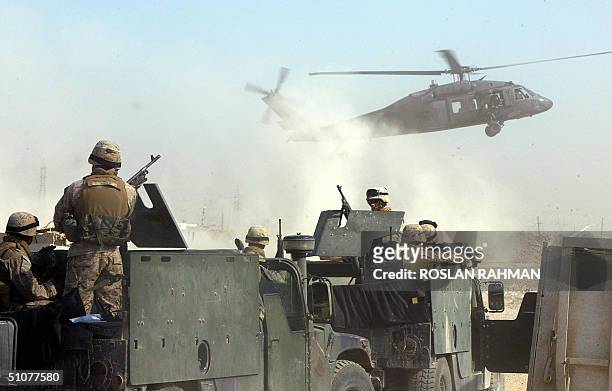Black Hawk helicopter lands in Saint Michael Camp in Mahmudiyah, some 60kms south of Baghdad 17 July 2004. A US soldier was killed yesterday after a...