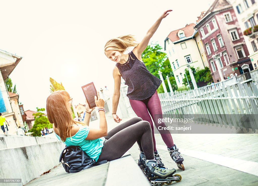 Teenage friends bonding together and having fun with rollerskate