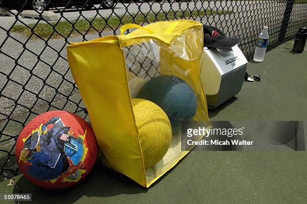 Equipment is seen on the side of the court as a group of adults, inspired by the recent movie 'Dodgeball' at a tennis court to play the sport July...