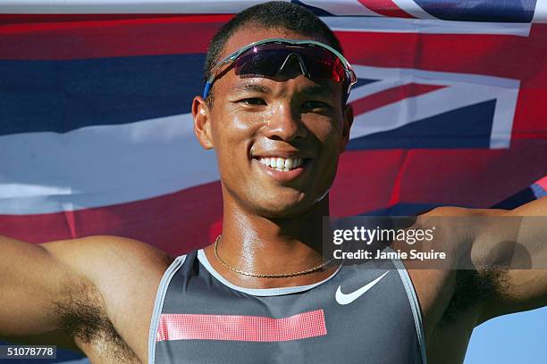 Bryan Clay holds up the Hawaiian flag while he celebrates winning the Decathlon during the U.S. Olympic Team Track & Field Trials on July 17, 2004 at...