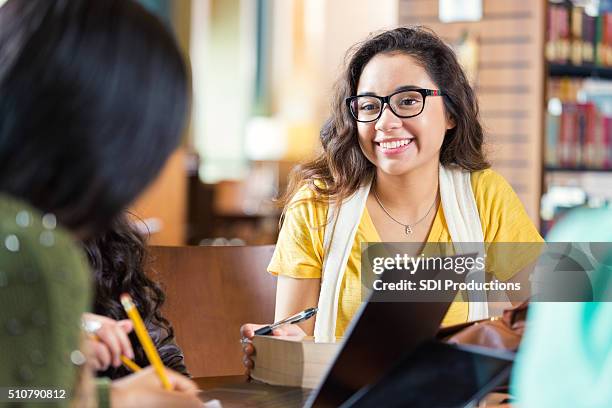 trendy college students hanging out in library while studying - high school student stock pictures, royalty-free photos & images