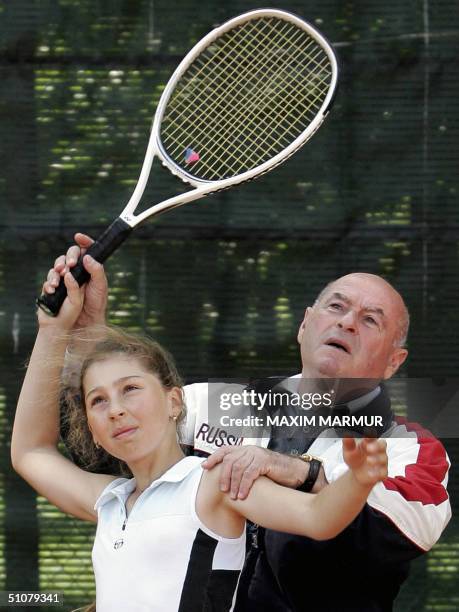 Vladimir Kamelzon, chief of the Russian Tennis Federation's trainers' council and director of a private tennis school, instructs 09 July 2004, the...