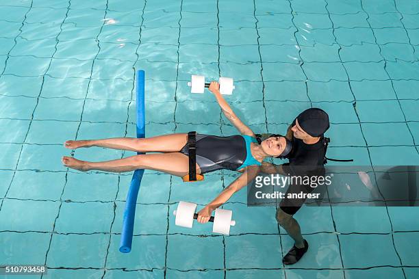 injured woman doing hydrotherapy - aquatic therapy stockfoto's en -beelden
