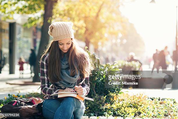 student girl studying in the campus. - teenager reading a book stock pictures, royalty-free photos & images