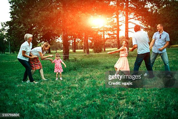 tug of war - extended family outdoors spring stock pictures, royalty-free photos & images