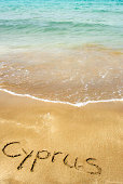 Cyprus written in sand on beach
