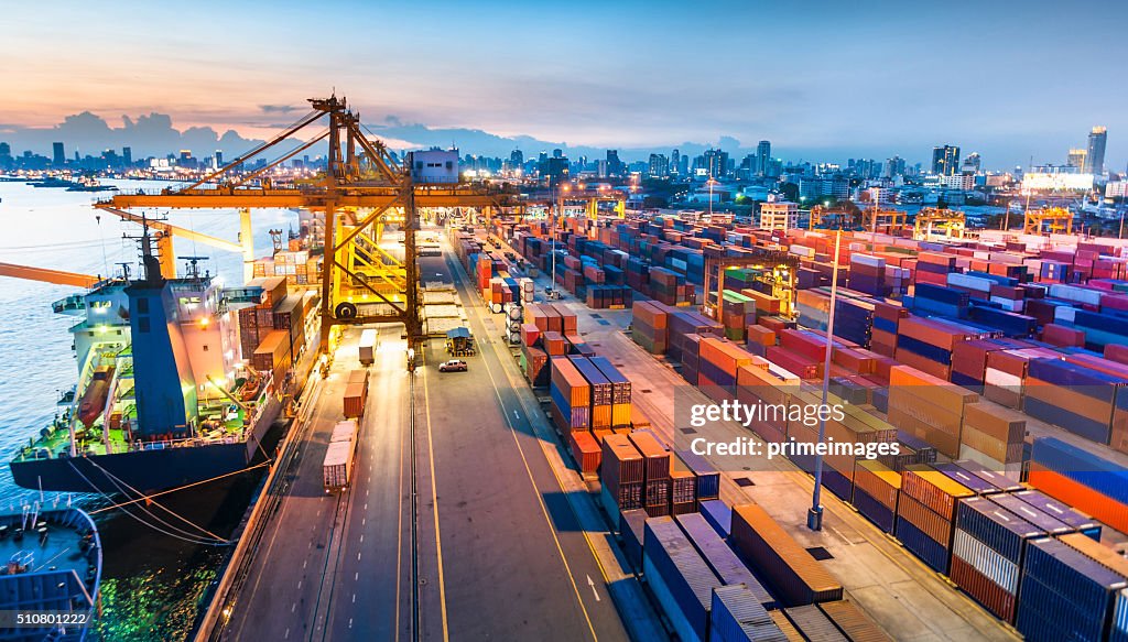 Cargo ship in the harbor at sunset .