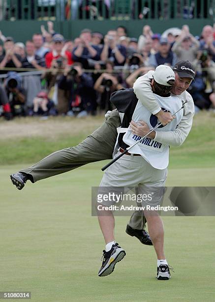 Todd Hamilton of the USA celebrates victory on the 18th green in the 133rd Open Championship with his caddy Ron Levin after a playoff at the Royal...