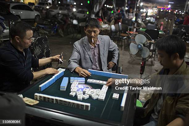 Men play Mah Jongg for money on February 16, 2016 in Mong La, Myanmar. Mong La, the capital of Myanmar's Special Region No. 4, is a mostly lawless...