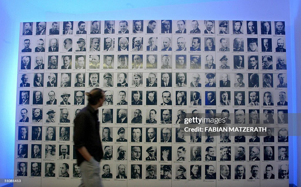 A visitor walks past a board displaying