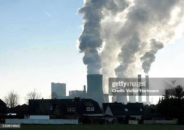 Steam rises from cooling towers at the RWE Niederaussem coal-fired power plant on February 16, 2016 near Bergheim, Germany. Germany is maintaining...